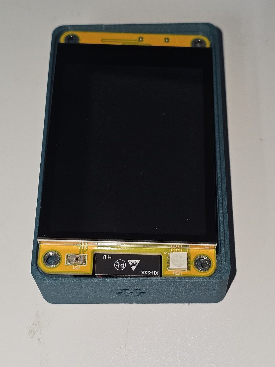 The board seated face up in the printed case, with the status LED visible at the bottom edge lining up with its indent in the case.